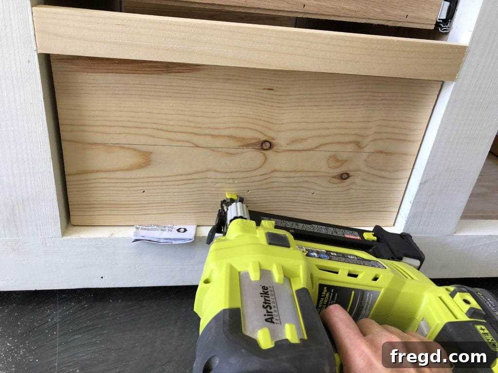 Attaching drawer faces to the installed drawers