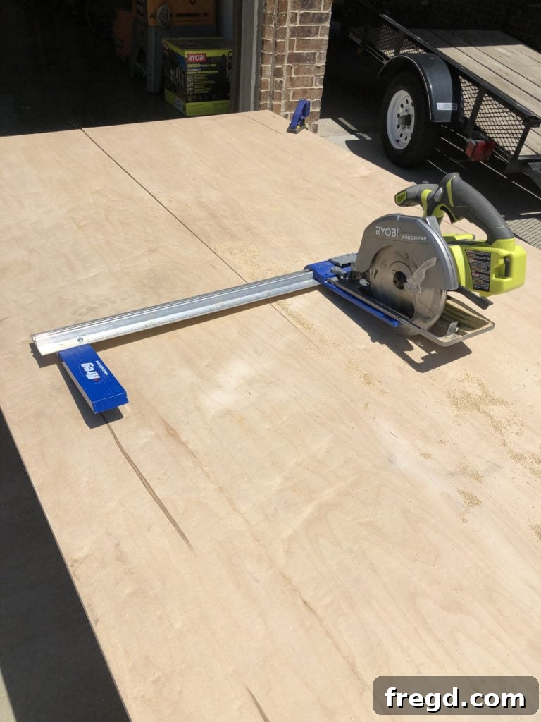 Cutting the plywood top for the dog crate console with a Kreg Rip Cut
