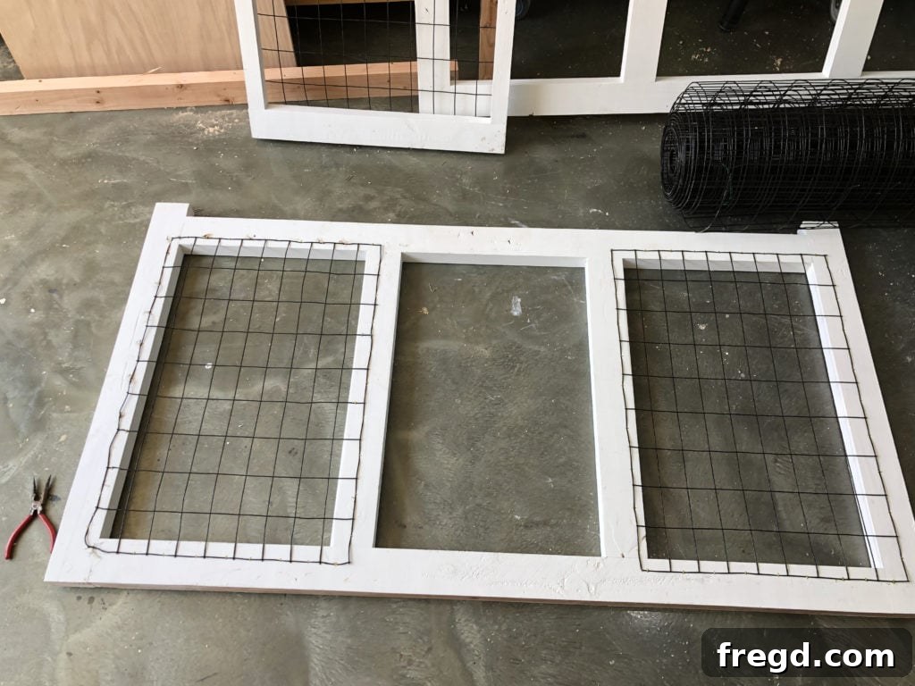 Attaching wire mesh to the back frame of the dog console
