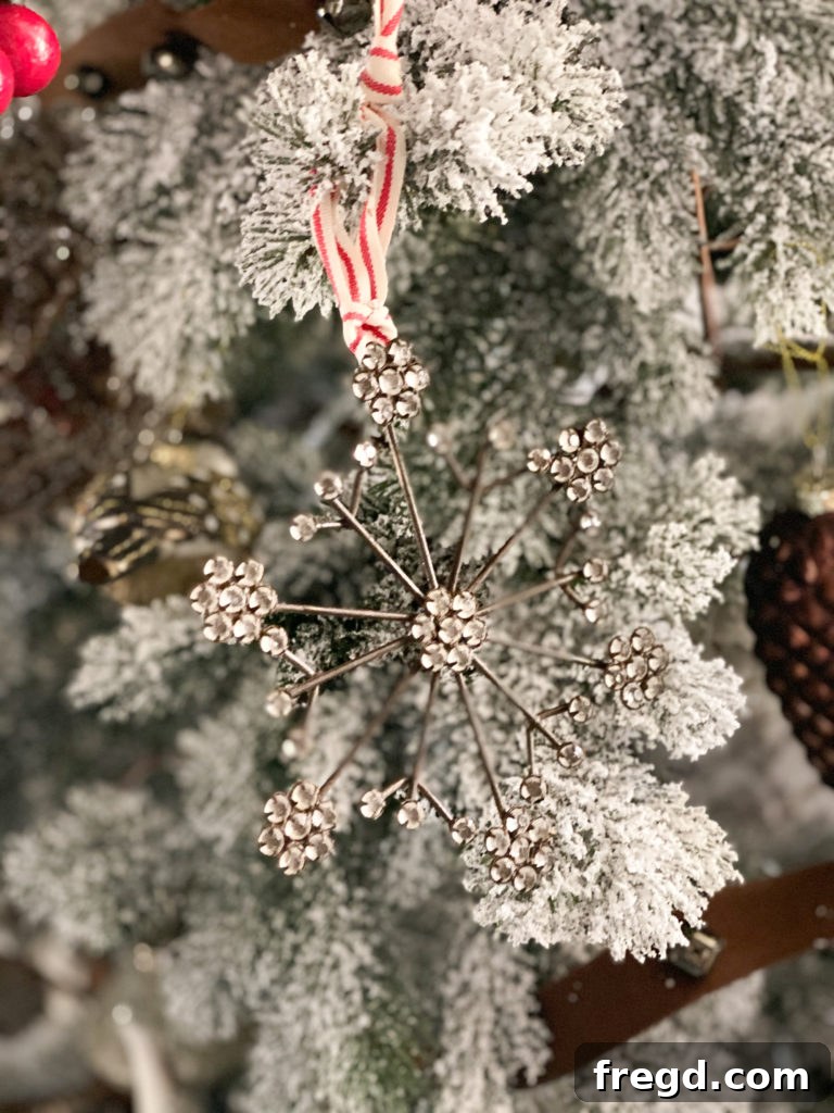 Close-up of an intricate antiqued snowflake ornament, highlighting its detailed design and frosted appearance.
