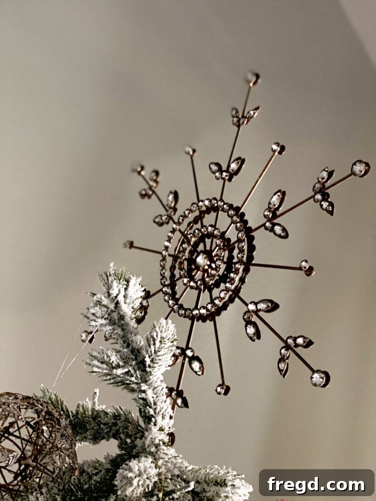 The stunning Antiqued Snowflake Tree Topper gracing the top of the Christmas tree.