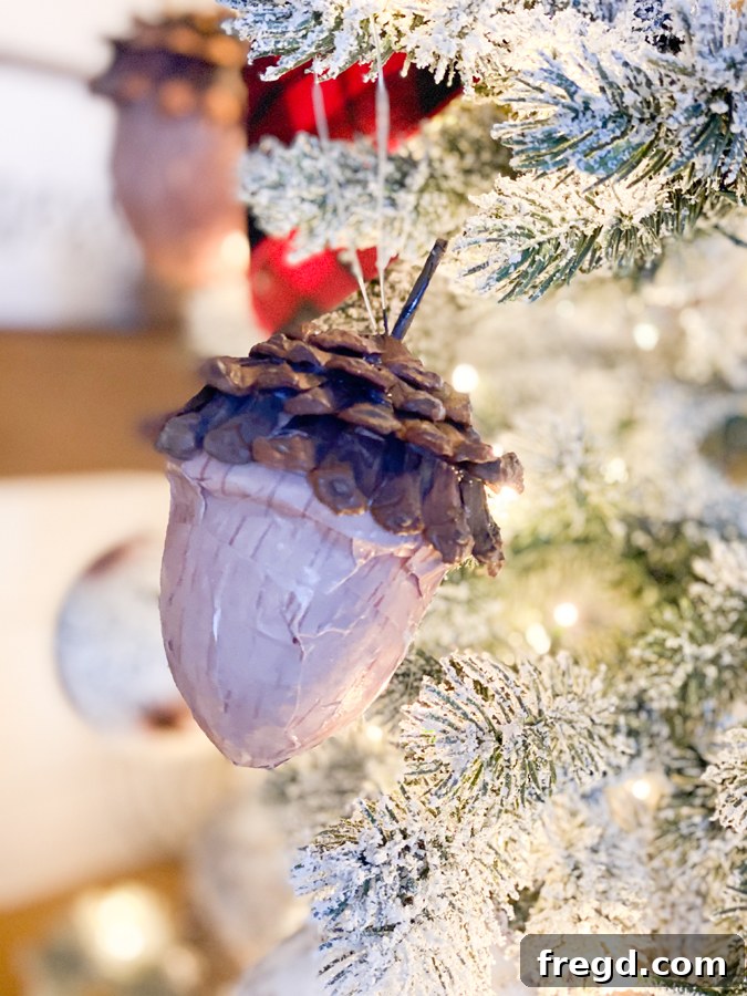 Sylvan Charm Christmas Tree 13 Close-up of a rustic bronze or copper colored ornament with a classic design.