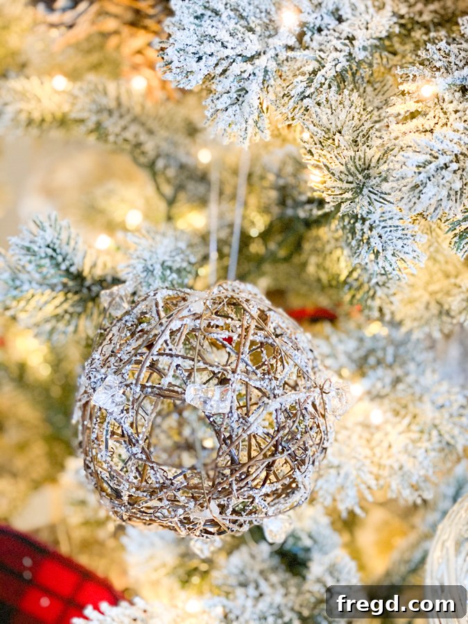 Sylvan Charm Christmas Tree 8 Close-up of a white owl ornament perched on a flocked branch, adding a touch of wildlife to the tree.