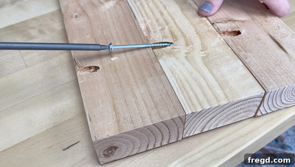 Homemade Canine Comfort 5 Close-up view of wooden planks being joined together using pocket hole screws, forming the robust base of the dog bed
