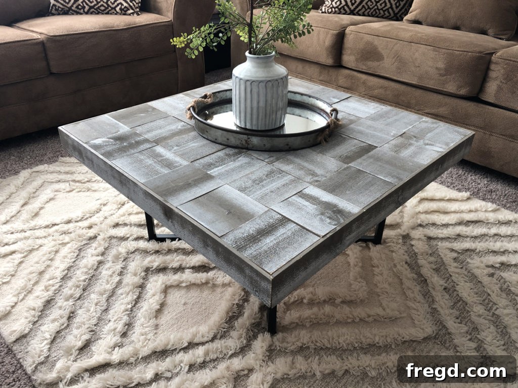 Beautifully finished DIY square coffee table with a wooden top and metal base, placed in a modern living space.