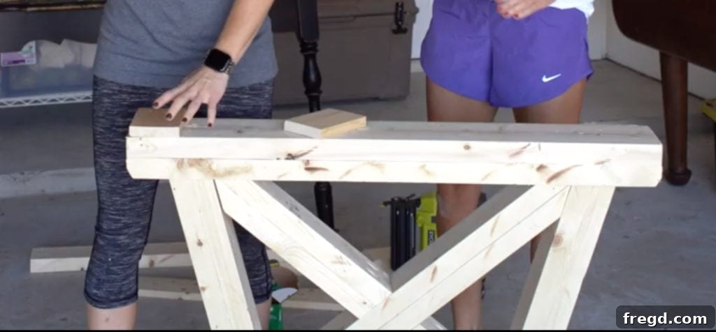 Attaching foot pads to the bottom of the table base