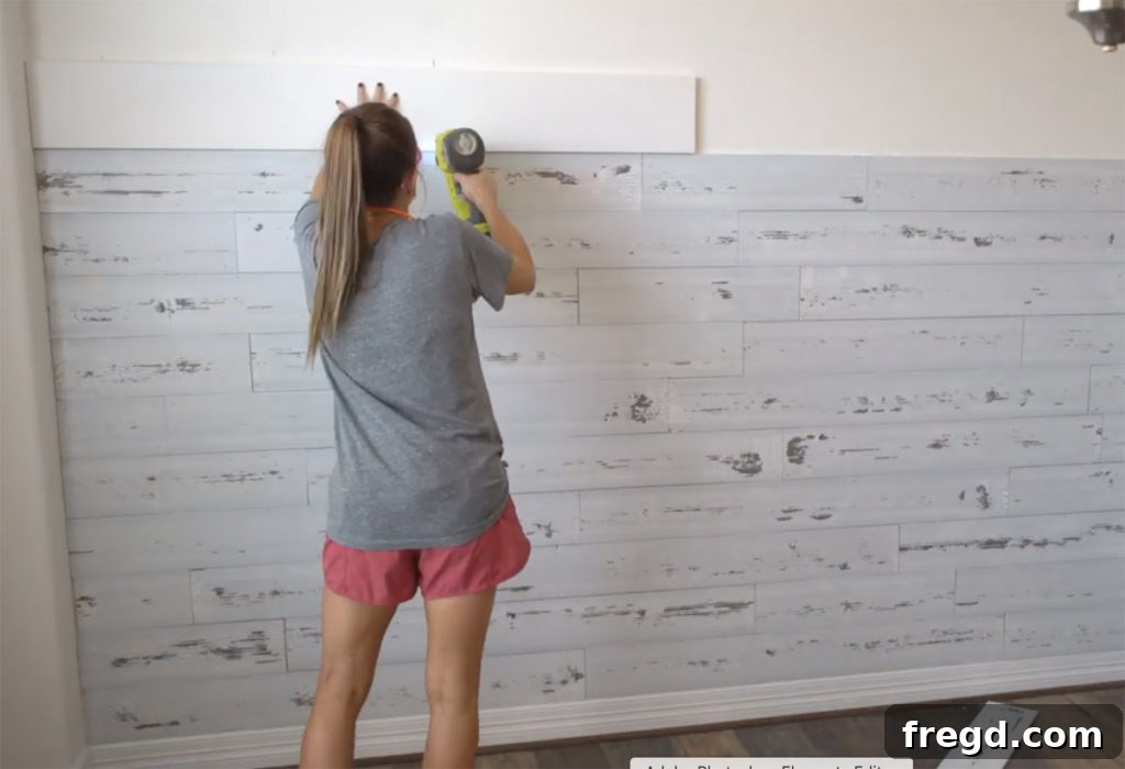 Quick and Easy Wood Plank Wall Upgrade 5 The completed wood plank wall with a sturdy 1x8 pine board cap, showing a professional finish