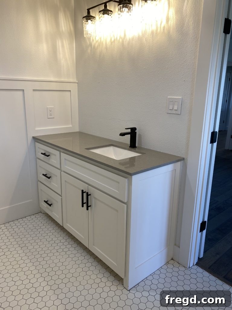 Shanty House Flip: The Nitty-Gritty Guide 8 Elegant gray Quartz countertop in the master bathroom, perfectly paired with white elements.