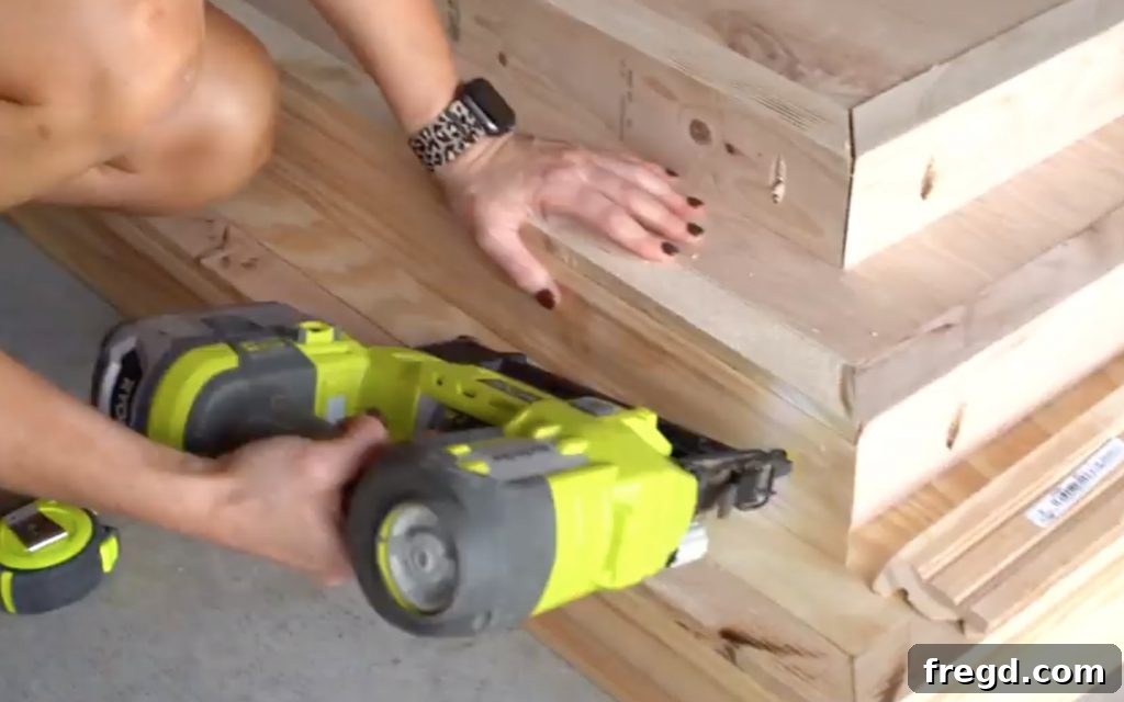 Adding trim to the second base tier for a finished edge.