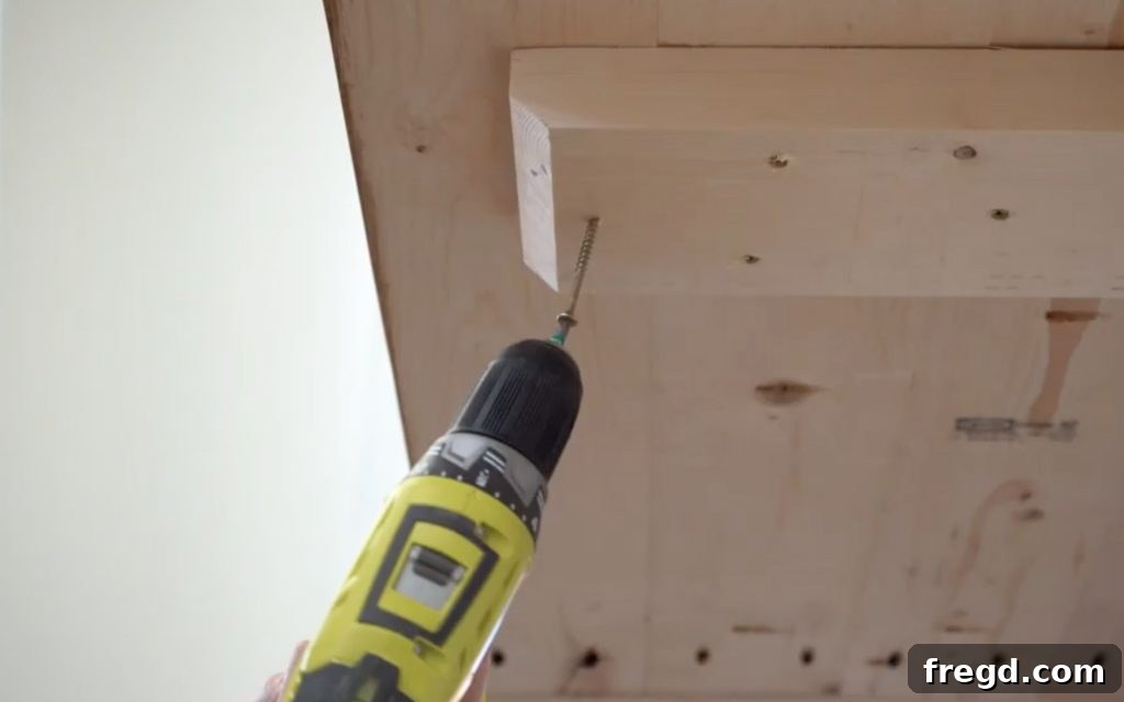 Table top being lowered onto the arm supports and secured from below.