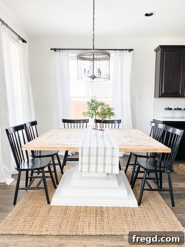 The square dining table set up in a dining room, ready for use.