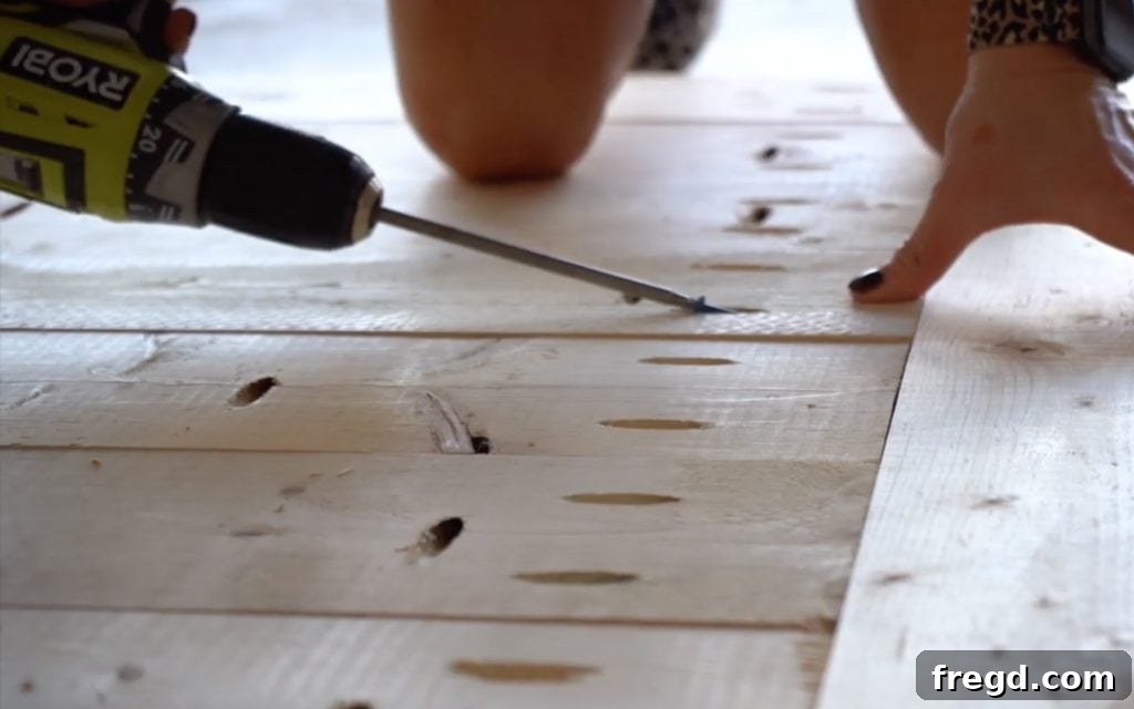 Breadboards being attached to the ends of the assembled table top.