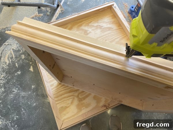 Casing being applied to the bottom base frame for a decorative edge.