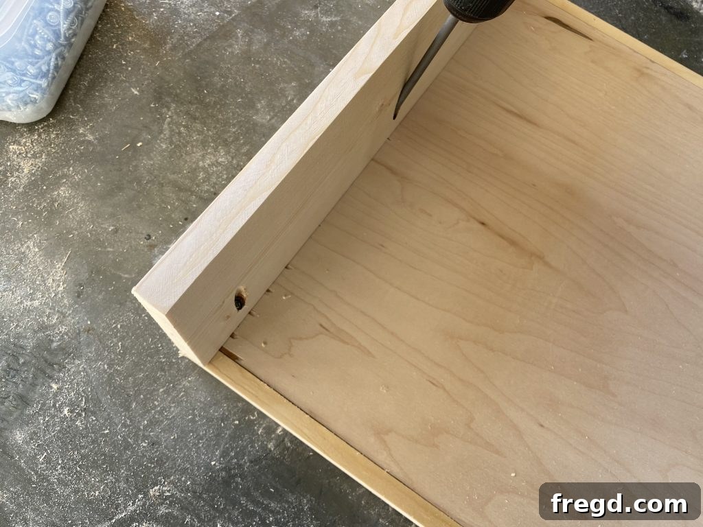 Attaching shelf side pieces to bottom shelf with pocket hole screws and wood glue