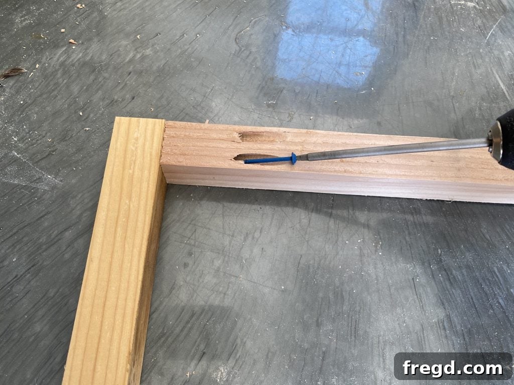 Attaching side frame pieces to the top frame piece with pocket hole screws