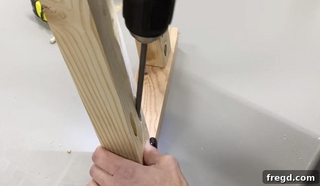 Partially assembled leg and top support with pocket holes and screws visible, showing the angled cut.