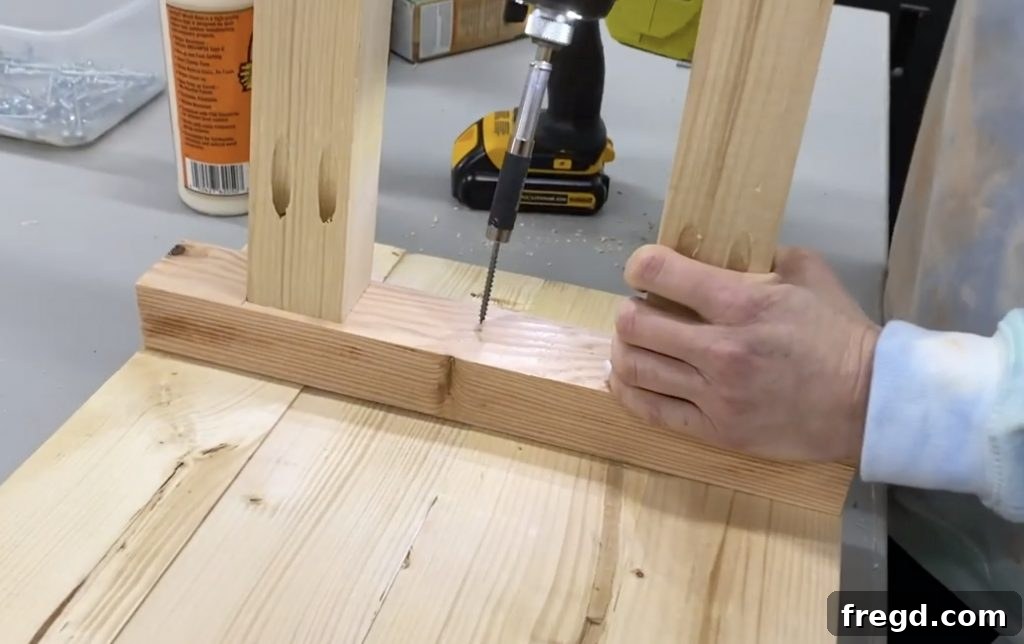 The assembled leg structures attached to the underside of the table top, forming the basic console table shape.