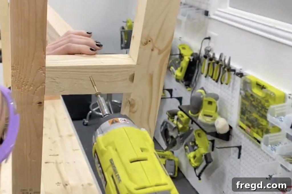 Close-up of the central runner being attached to the bottom leg supports with screws.
