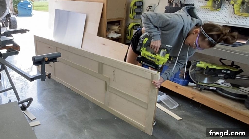 Attaching the side trim pieces to the barn door, flush with the front.