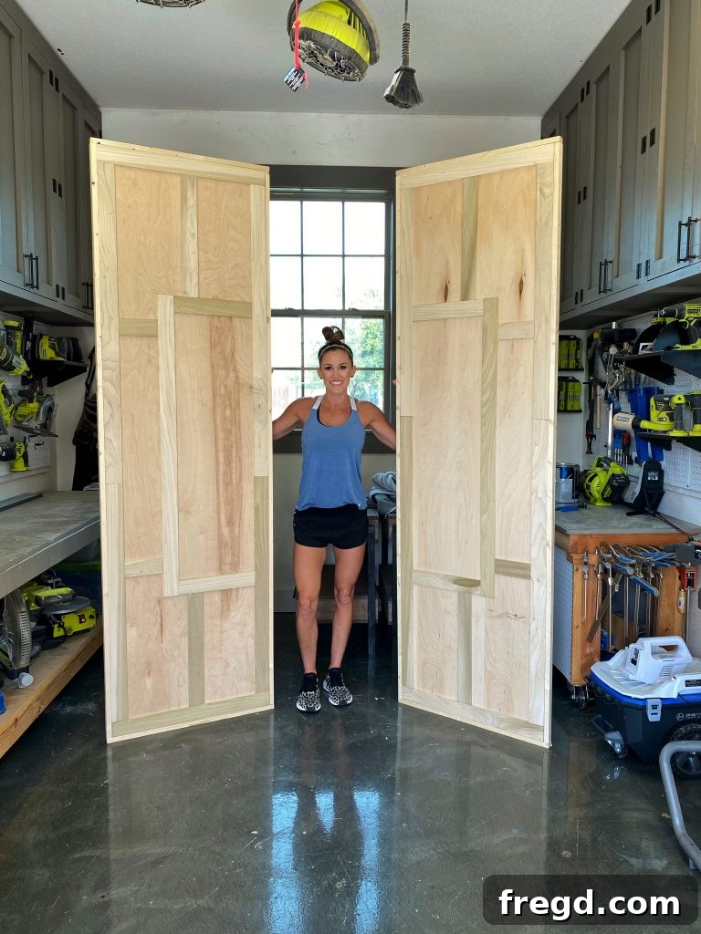 The barn door after wood filler has been applied to nail holes and seams.