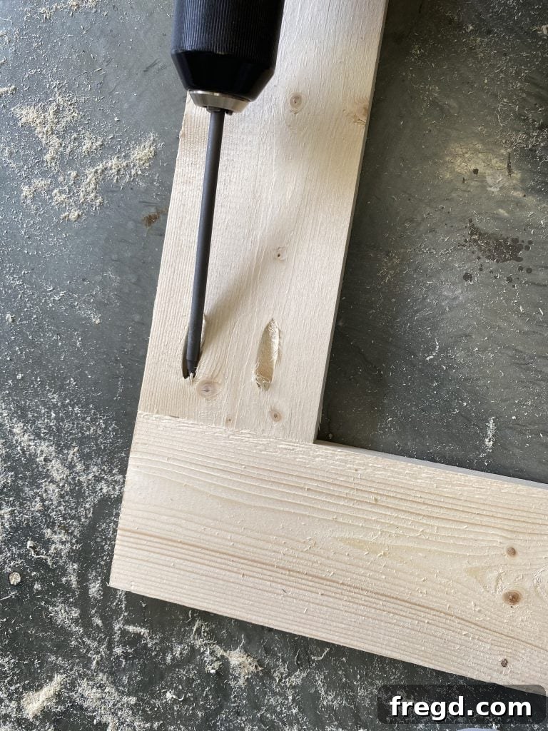 Close-up of pocket holes drilled into a wooden frame piece.