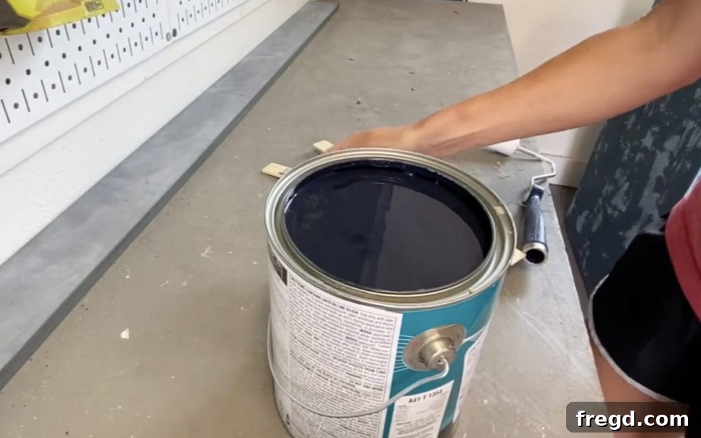 Your Guide to Furniture Makeovers 8 Applying Tricorn Black paint to the dresser