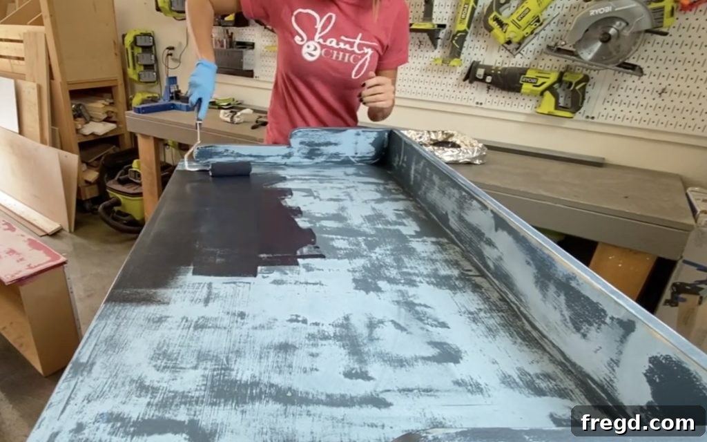 Your Guide to Furniture Makeovers 9 Painting dresser drawers with a foam roller