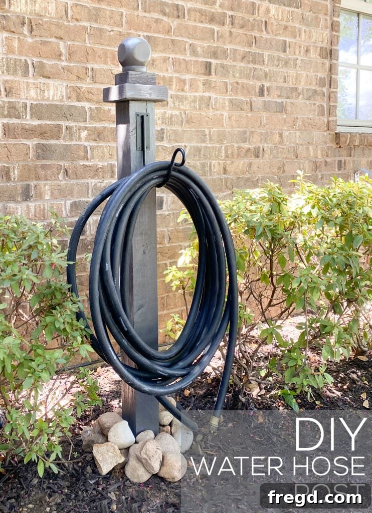 Installed DIY Water Hose Post in the garden, holding a coiled hose