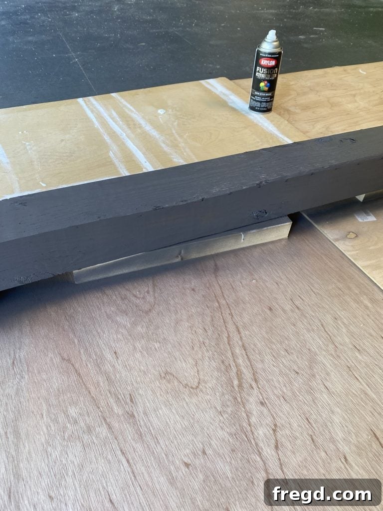 Hose post elevated on scrap wood for painting
