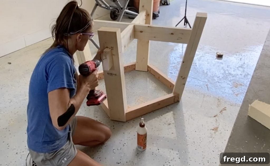 Fastening the decorative pieces to each table leg with wood screws and glue.