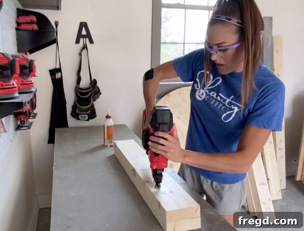 Assembling individual table leg components with brad nails and wood glue.
