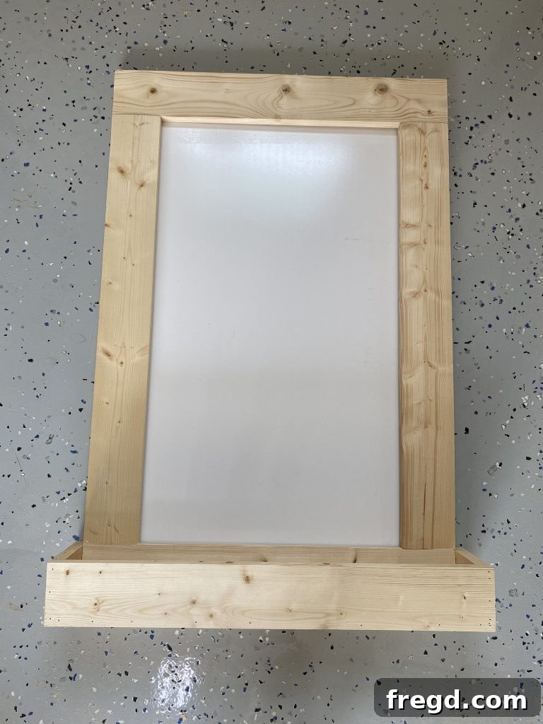 Your DIY Dry Erase Canvas 12 Wooden frame of the dry erase board laid over the white dry erase surface for positioning