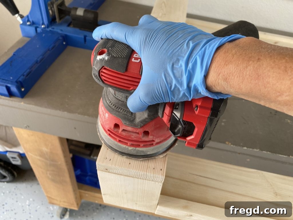 Your DIY Dry Erase Canvas 15 Close-up of a wooden frame being sanded to prepare for staining