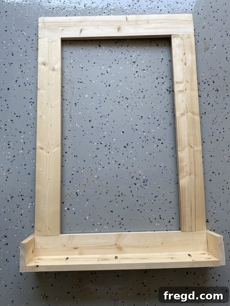 Your DIY Dry Erase Canvas 10 Wooden frame with the base and side supports of the cup holder fully assembled