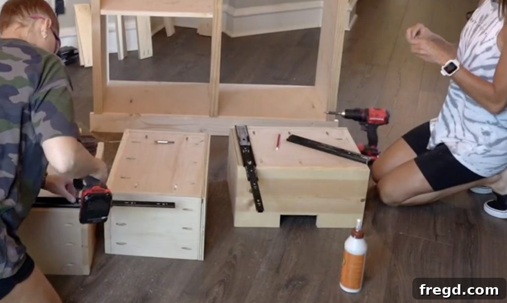 Drawers being installed into the cabinet with drawer slides