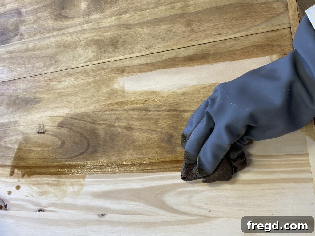 Build Your Own Square Coffee Table 14 Wiping off excess Minwax stain for an even, consistent wood finish