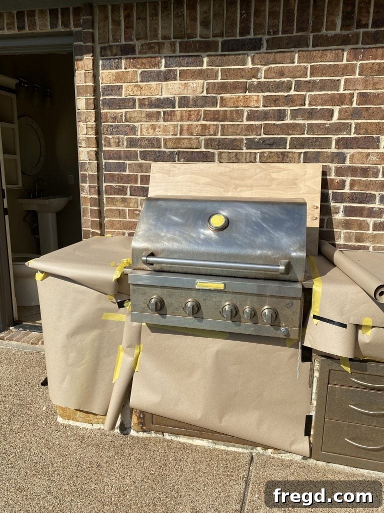 Transform Your Rusty Grill: Paint It Like New 4 Outdoor grill meticulously masked with painter's tape and contractor paper, protecting areas from overspray before painting.