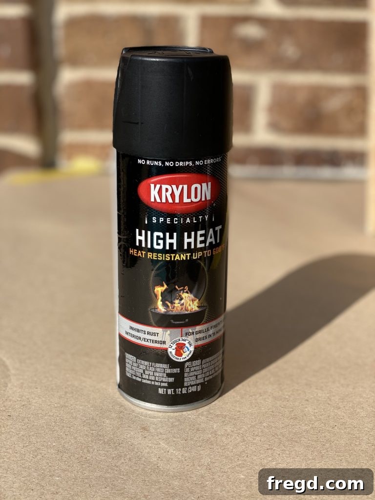 Transform Your Rusty Grill: Paint It Like New 5 Hand applying Krylon High Heat Spray Paint in matte black onto the prepared grill surface.