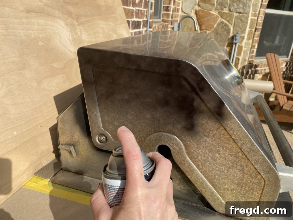 Transform Your Rusty Grill: Paint It Like New 6 Close-up of the grill surface receiving a very light, even coat of high-heat spray paint to prevent drips.