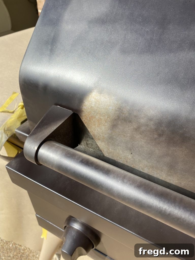 Transform Your Rusty Grill: Paint It Like New 7 Outdoor grill after receiving multiple thin coats of high-heat black spray paint, showing even coverage.