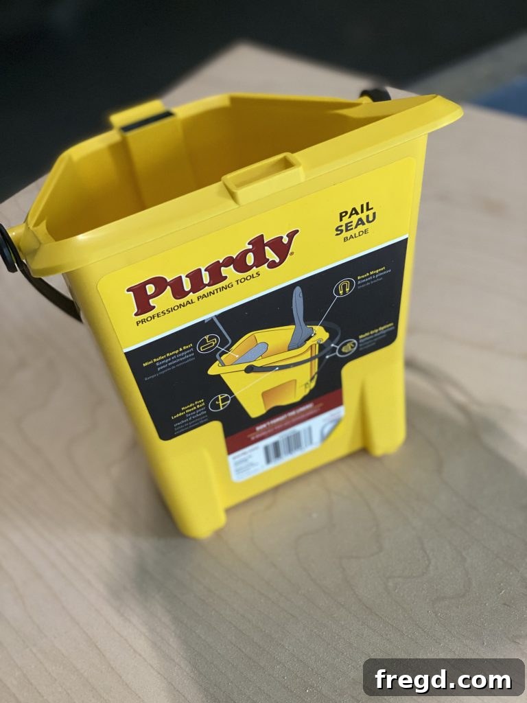 The Purdy Pail in use during the painting process, demonstrating its convenient design.