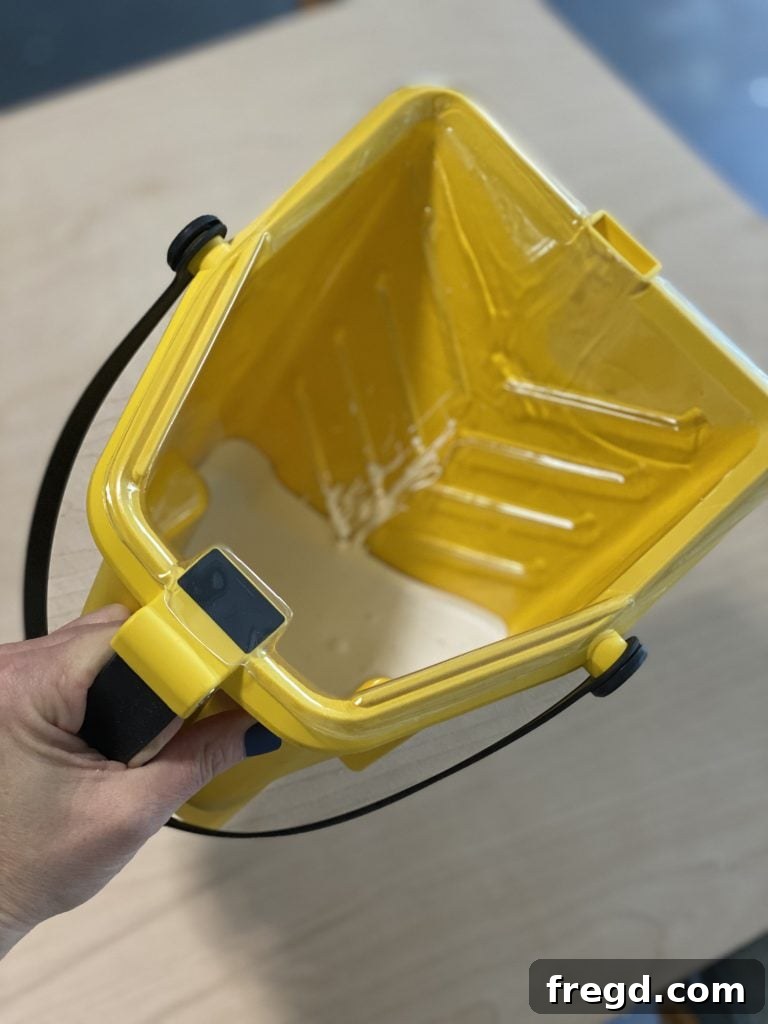 Side view of the Purdy Pail, showcasing its ergonomic design for comfortable use.