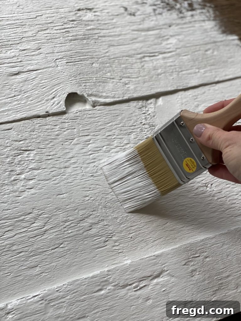 The entire barn wood surface painted with a thick coat of Sherwin-Williams Pure White.