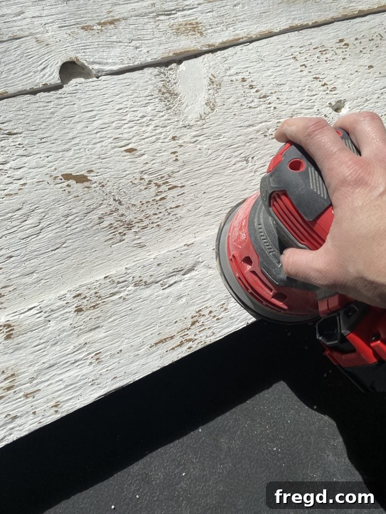 Close-up of the distressed painted surface, revealing glimpses of the natural wood underneath.