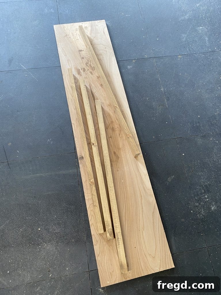Stained 1x2 boards laid out, ready to be attached as the decorative frame.