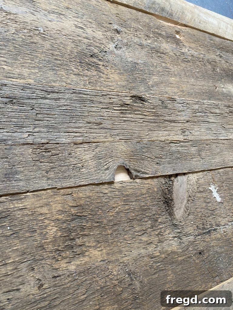 The barn wood surface prepared for painting, showing its natural texture.