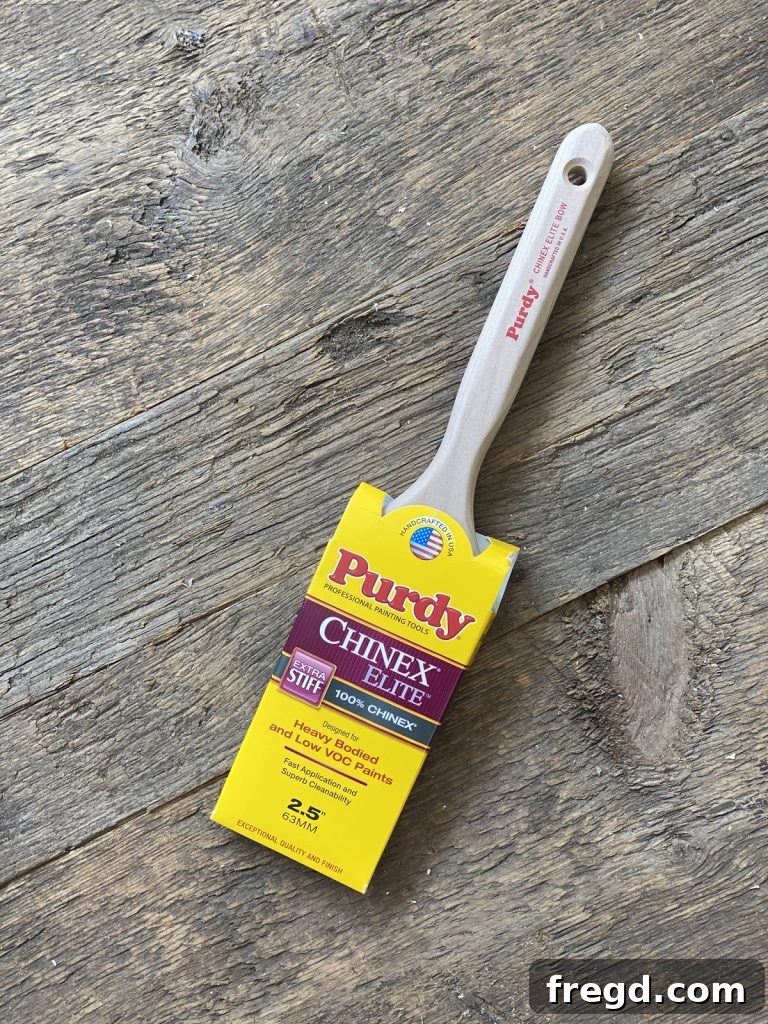 Applying paint to the textured barn wood surface using a Purdy Chinex Elite brush.