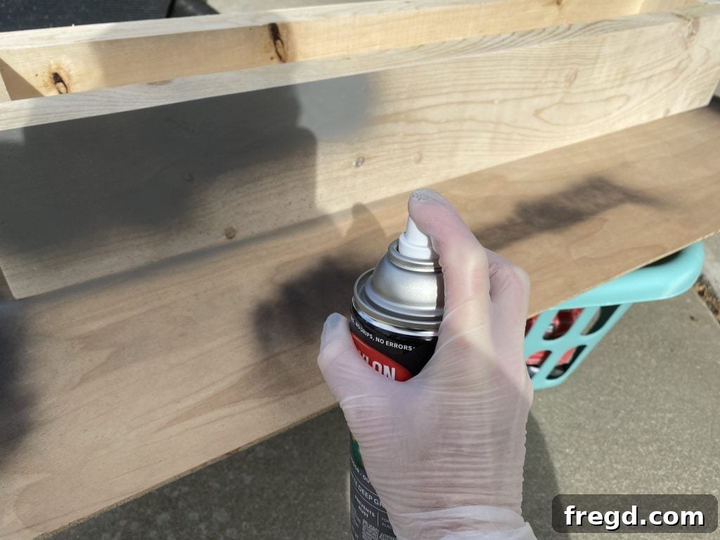 The wooden stocking holder after receiving its first coat of Krylon spray paint, showing even coverage.