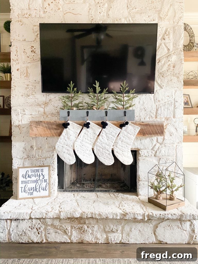 A beautifully styled DIY stocking holder positioned on a console table, showcasing its versatility as a mantel alternative.