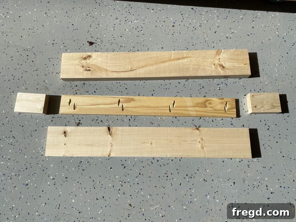 Close-up of cut wood pieces with pocket holes drilled along the edges, ready for assembly using pocket hole screws.